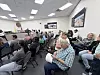 Residents seated in a crowded City Council chamber during a public meeting.